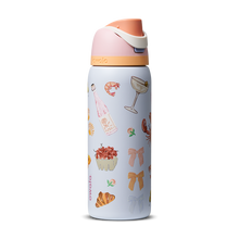 FreeSip 32oz in Picnic Prep, light periwinkle blue body with scattered picnic-themed print (croissants bows cocktail glasses) and peach-salmon flip cap
