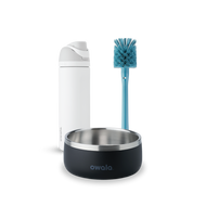 Owala FreeSip and Pet Bowl Bundle showing a white FreeSip bottle, a teal-handled bottle brush with blue bristles, and a dark charcoal stainless steel pet bowl with white Owala logo